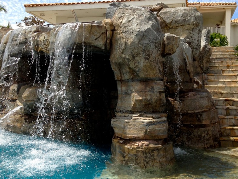 Custom waterfall feature, creating a serene and luxurious atmosphere perfect for relaxation and enjoyment.
