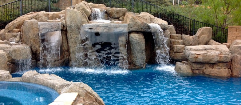 Pool with multiple cascading waterfalls, creating a really fun atmosphere ideal for people of all ages to enjoy.