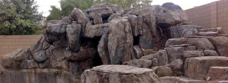 Rockscape with slide, blending natural rock formations with playful features, providing a unique and adventurous outdoor play area for children