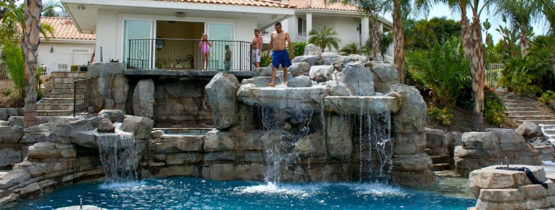 Pool with multiple cascading waterfalls, creating a picturesque and serene atmosphere ideal for relaxation and enjoyment