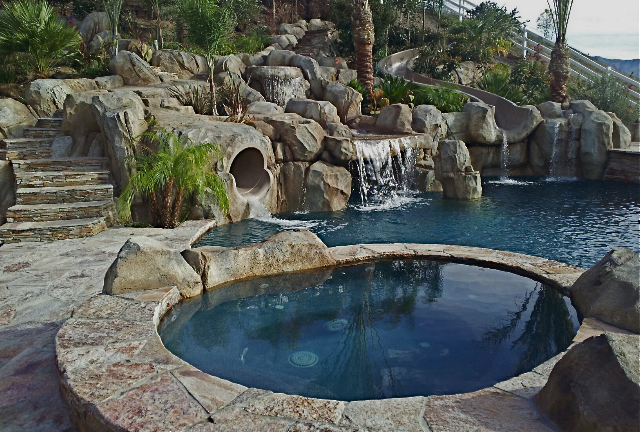 Waterslide made from artificial rocks by a Southern California Pool construction company, providing thrilling outdoor entertainment and adventure for all ages