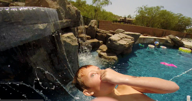 Boy Jumping into pool for a refreshing swim in Fountain Valley, CA