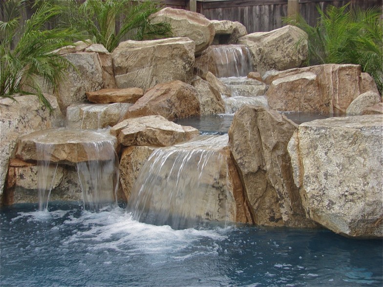 Custom waterfall feature, creating a serene and luxurious atmosphere perfect for relaxation and enjoyment.